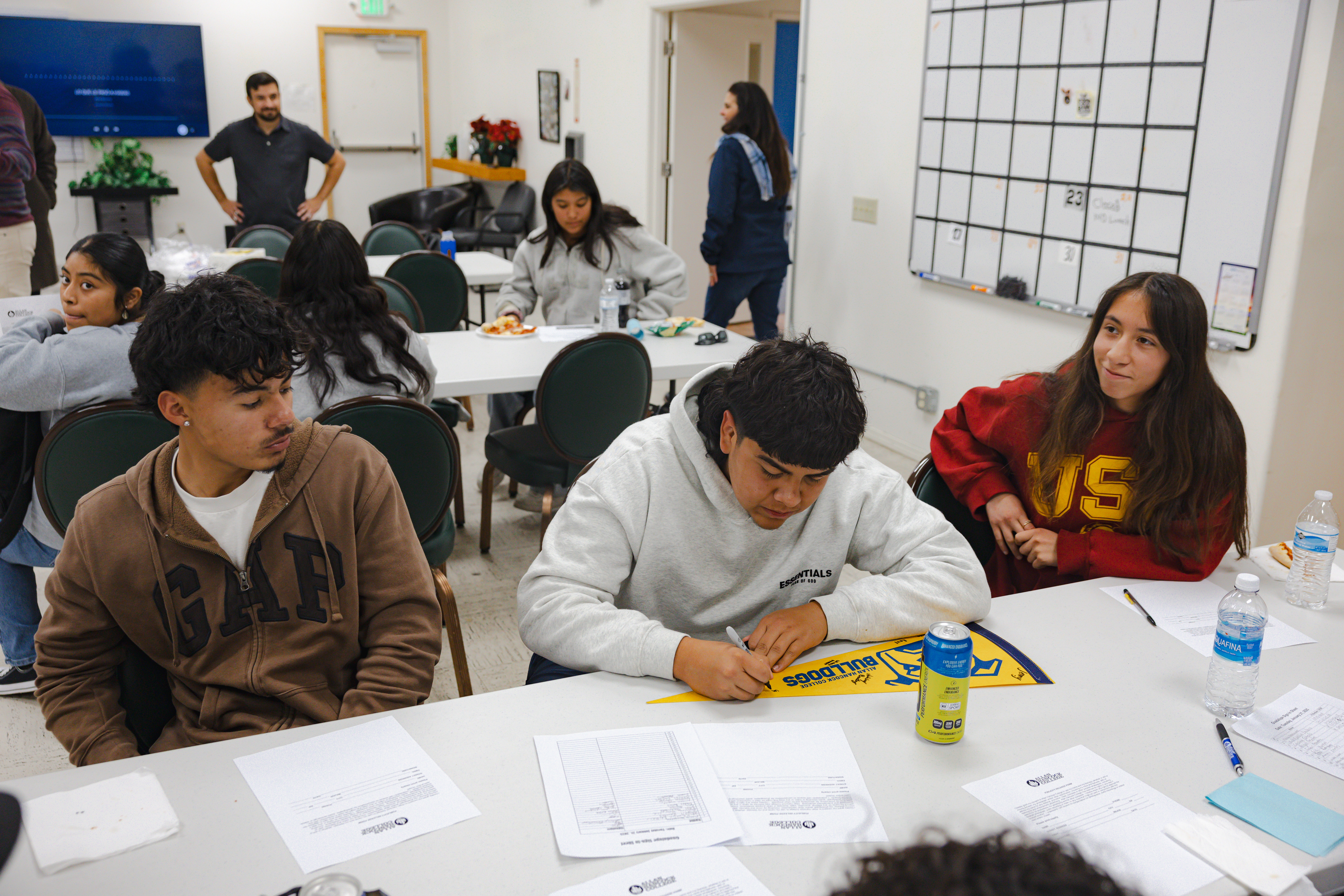 High school students sit at a table in Guadalupe.